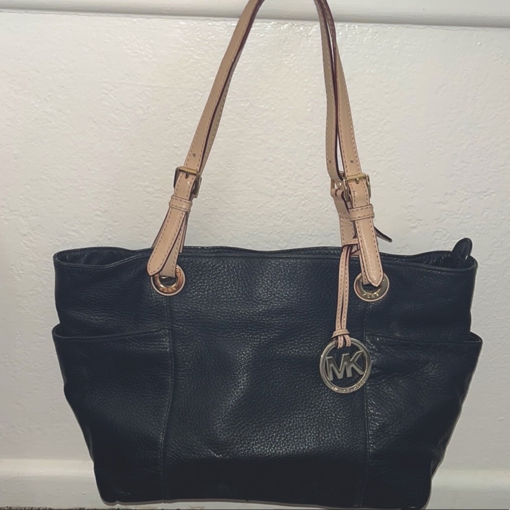 Michael Kors bag with gold hardware and cream colored straps